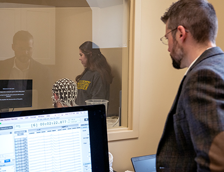 photo of Dr. Patrick Ledwidge reading EEG data